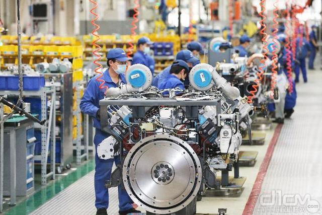 在潍柴大缸径高端高速发动机工厂,工人们正在装配发动机零部件(潍柴